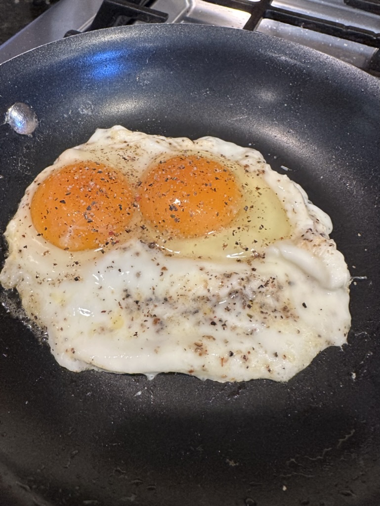 Over easy eggs with salt and pepper